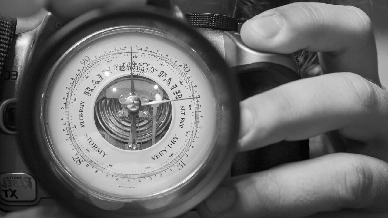 Experimenting with reflections, specifically the high albedo surface of a hard drive platter. Attempting to focus on both the reflected background (camera and I) and an object through the center portion of the disk (barometer).