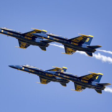 U.S. Navy Blue Angels flying in a close diamond formation.