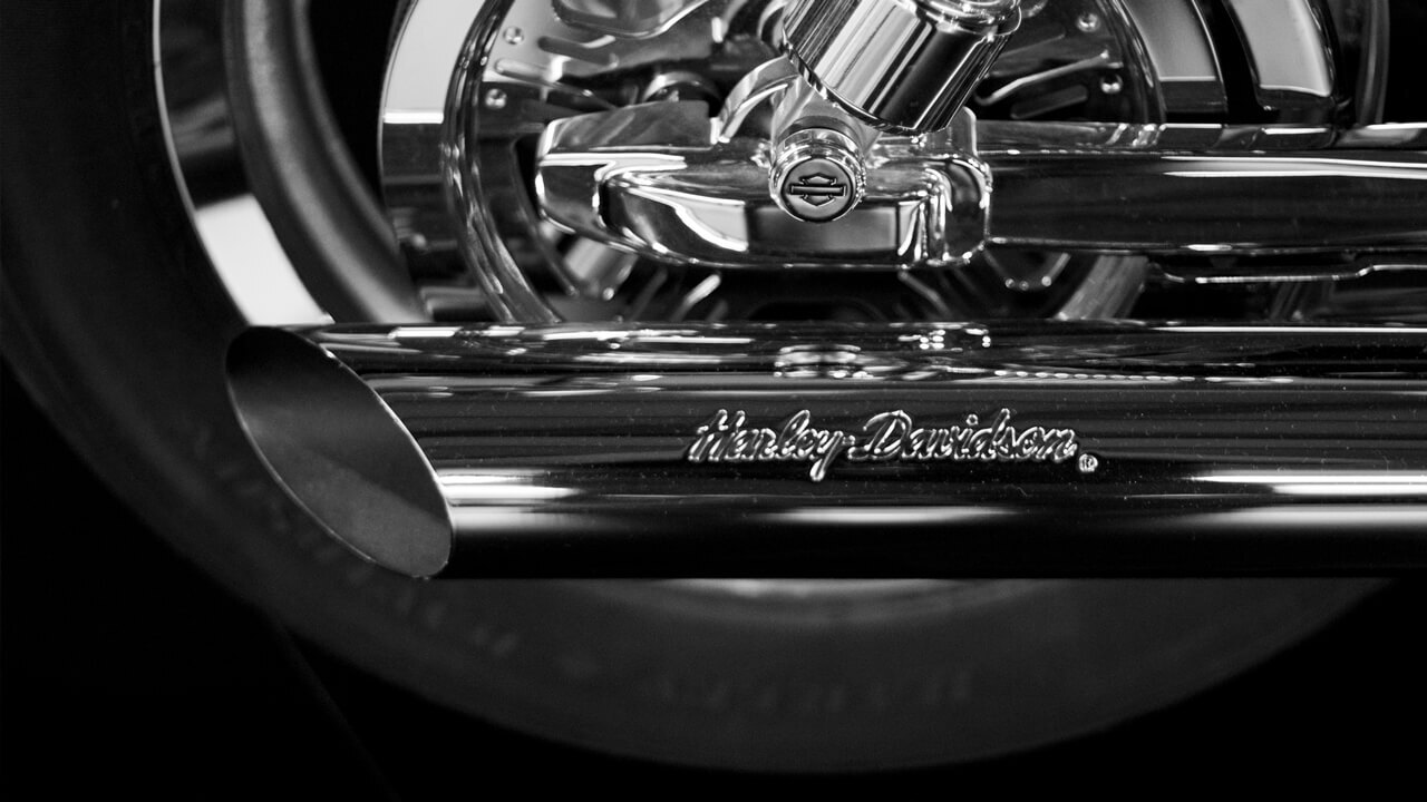 Harley-Davidson exhaust pipe and rear wheel.